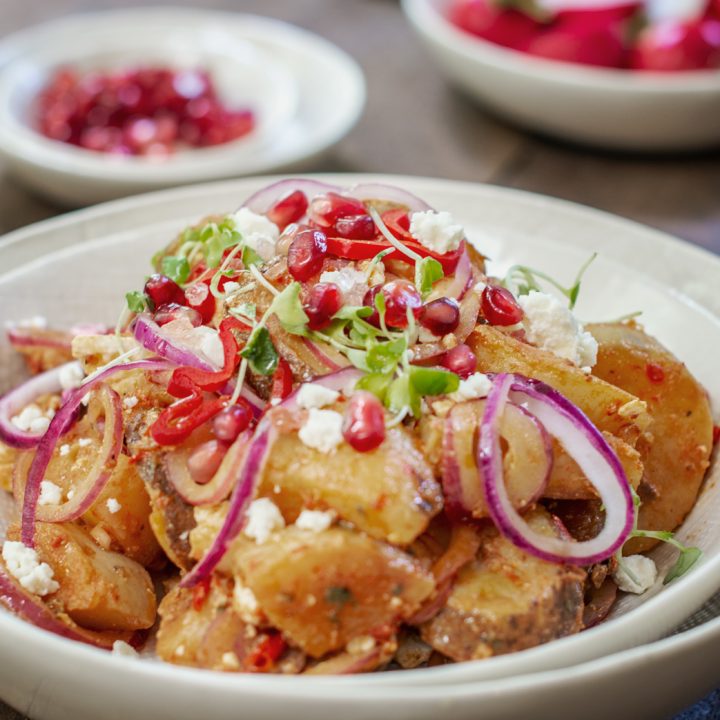 White bowl with Moroccan Potato Salad on wood table