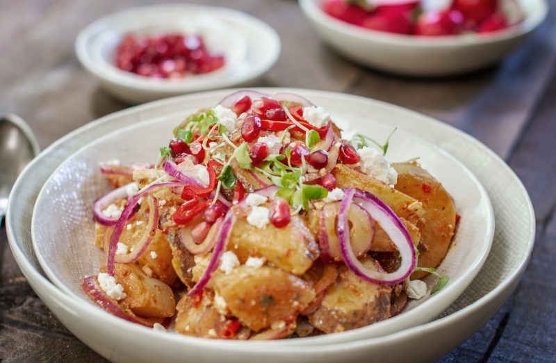 White bowl with Moroccan Potato Salad on wood table