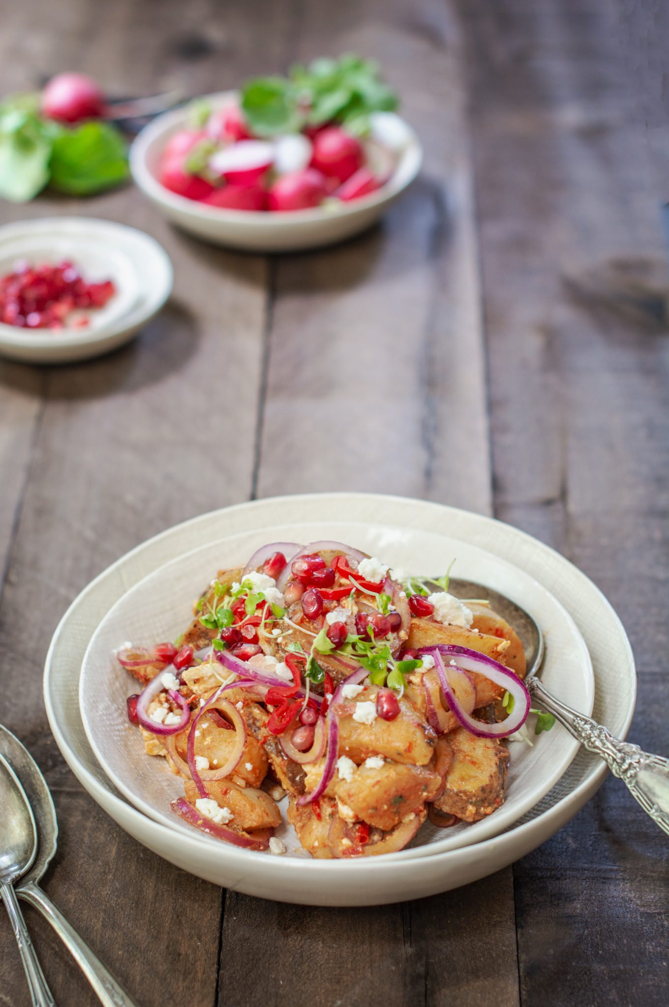 Brown table with potato salad in white bowls