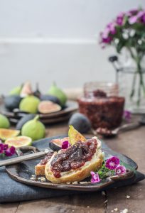 A fig jam recipe spread over a crusty piece of toasted bread.