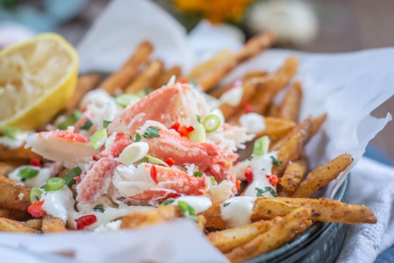 Enjoying Loaded Crab Fries with garlic aioli